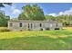 A home with an overgrown lawn and mature trees at 1294 1/2 38Th Nw St, Winter Haven, FL 33881