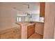 A wet bar leads to an open living area, revealing a partial kitchen view, with a clear view into other rooms at 1294 1/2 38Th Nw St, Winter Haven, FL 33881