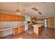 Bright kitchen equipped with stainless steel appliances and lots of wooden cabinets, under recessed lights and skylights at 1294 1/2 38Th Nw St, Winter Haven, FL 33881