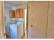 Laundry room with washer, dryer and upper cabinets with entry to bathroom at 1294 1/2 38Th Nw St, Winter Haven, FL 33881