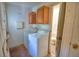 Laundry room with washer, dryer and upper cabinets with entry to bathroom at 1294 1/2 38Th Nw St, Winter Haven, FL 33881