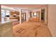 Open-concept living area showcases bar seating with adjacent kitchen featuring wood cabinetry and stainless-steel appliances at 1294 1/2 38Th Nw St, Winter Haven, FL 33881