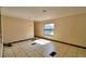 A living room with tiled floor and one window at 1294 1/2 38Th Nw St, Winter Haven, FL 33881