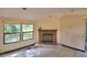 Bright living room featuring a classic brick fireplace and multiple windows at 1294 1/2 38Th Nw St, Winter Haven, FL 33881