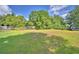 An expansive green lawn is showcased with mature trees and foliage at 1294 1/2 38Th Nw St, Winter Haven, FL 33881