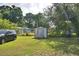 View of the backyard showing a shed, car and equipment at 1294 1/2 38Th Nw St, Winter Haven, FL 33881