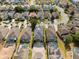 Aerial view of a well-maintained home with a clean roof, lush backyard, and a refreshing pool at 135 Minniehaha Cir, Haines City, FL 33844