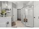 Modern bathroom featuring a glass-enclosed shower and neutral tile flooring at 135 Minniehaha Cir, Haines City, FL 33844
