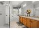 Bright bathroom featuring dual vanities, soaking tub, and a walk-in shower at 135 Minniehaha Cir, Haines City, FL 33844