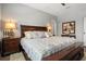 Bright primary bedroom featuring a large bed and two nightstands at 135 Minniehaha Cir, Haines City, FL 33844