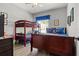 bedroom featuring wooden bunkbeds, a TV and a ceiling fan at 135 Minniehaha Cir, Haines City, FL 33844
