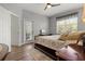 Well-lit bedroom featuring a large bed, a ceiling fan and access to the backyard at 135 Minniehaha Cir, Haines City, FL 33844