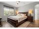 Well-lit primary bedroom featuring a large bed, a ceiling fan and two nightstands at 135 Minniehaha Cir, Haines City, FL 33844