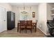 Bright dining room with a stylish light fixture and a dark cabinet at 135 Minniehaha Cir, Haines City, FL 33844