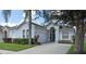 Charming single-story home with well-manicured lawn, two-car garage, and front yard trees at 135 Minniehaha Cir, Haines City, FL 33844