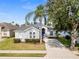 Charming single-story home with a well-manicured lawn, mature trees, and a welcoming blue front door at 135 Minniehaha Cir, Haines City, FL 33844