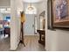 Welcoming foyer with arched window above the front door and handsome wood floors with views to other rooms at 135 Minniehaha Cir, Haines City, FL 33844
