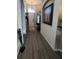 Hallway featuring art display and wood look floors leading to the front door at 135 Minniehaha Cir, Haines City, FL 33844