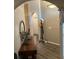 Hallway with wood flooring and arched doorways featuring decor and neutral paint at 135 Minniehaha Cir, Haines City, FL 33844