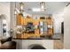 Kitchen boasts bar seating, decorative upper shelves, stainless appliances and tiled backsplash at 135 Minniehaha Cir, Haines City, FL 33844