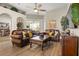 Comfortable living room with wood floors, leather sofas, and an open floor plan at 135 Minniehaha Cir, Haines City, FL 33844