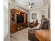 Comfortable living room with tray ceiling, rich wood entertainment center, and recliner seating at 135 Minniehaha Cir, Haines City, FL 33844