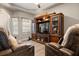 Inviting living room featuring a large entertainment center and reclining sofas in neutral colors at 135 Minniehaha Cir, Haines City, FL 33844