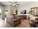 Cozy living room with a ceiling fan, a TV and a leather sofa at 135 Minniehaha Cir, Haines City, FL 33844