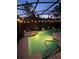 Enjoy this private, screened-in pool at dusk with landscape lighting at 135 Minniehaha Cir, Haines City, FL 33844