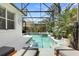 Backyard pool featuring clear water and cozy lounge chairs, all surrounded by verdant landscaping at 135 Minniehaha Cir, Haines City, FL 33844