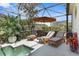 Inviting outdoor living space with a pool, lounge chairs, and shaded area, perfect for entertaining at 135 Minniehaha Cir, Haines City, FL 33844