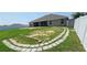 Expansive backyard features a stone-lined walkway, lush lawn area, and a secure white vinyl privacy fence at 1400 Eagle Crest Blvd, Winter Haven, FL 33881