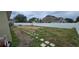 Large backyard featuring a lawn, stepping stones, and a secure white fence at 1400 Eagle Crest Blvd, Winter Haven, FL 33881
