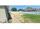 Partially sodded back and side yard bordered by a white vinyl fence with stone walkway at 1400 Eagle Crest Blvd, Winter Haven, FL 33881