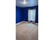 Bright bedroom features plush carpet, light-filtering curtains, and a fresh coat of bold blue paint at 1400 Eagle Crest Blvd, Winter Haven, FL 33881