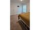 Bedroom showcasing light-filled space with carpeted floors and a window at 1400 Eagle Crest Blvd, Winter Haven, FL 33881