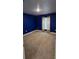 Bedroom with neutral carpet, blue painted walls, and natural light from a window at 1400 Eagle Crest Blvd, Winter Haven, FL 33881