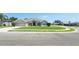 Inviting front yard with a well-maintained lawn, featuring a driveway and charming curb appeal in a neighborhood setting at 1400 Eagle Crest Blvd, Winter Haven, FL 33881