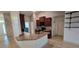 Open kitchen featuring stainless steel sink, brown cabinets, tile backsplash, and breakfast bar at 1400 Eagle Crest Blvd, Winter Haven, FL 33881