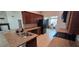 Well-equipped kitchen with dark cabinets, featuring stainless steel appliances and a glimpse of the adjacent living area at 1400 Eagle Crest Blvd, Winter Haven, FL 33881
