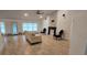 Bright living room features tile flooring, a fireplace, a ceiling fan, and plentiful natural light at 1400 Eagle Crest Blvd, Winter Haven, FL 33881