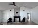 Stylish living room featuring a modern fireplace, neutral walls, and two plush decorative chairs at 1400 Eagle Crest Blvd, Winter Haven, FL 33881