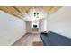 Inviting living room with a wooden ceiling, white walls, and a cozy blue futon with a colorful rug at 1515 W Lake Cannon Nw Dr, Winter Haven, FL 33881