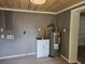 Utility room with a modern sink, water heater, and hook ups for a washing machine at 1515 W Lake Cannon Nw Dr, Winter Haven, FL 33881