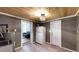 Utility room with a water heater and a sink, adjacent to a living space with a comfortable futon at 1515 W Lake Cannon Nw Dr, Winter Haven, FL 33881