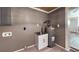 Functional utility room featuring a water heater, sink, and ample space for storage at 1515 W Lake Cannon Nw Dr, Winter Haven, FL 33881