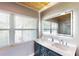 Modern bathroom features a large illuminated mirror above the dual sink vanity and a tongue and groove ceiling at 1515 W Lake Cannon Nw Dr, Winter Haven, FL 33881