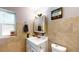 Cozy bathroom with a white vanity, toilet, medicine cabinet, and a window letting in natural light at 1515 W Lake Cannon Nw Dr, Winter Haven, FL 33881