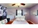 This bedroom has hardwood floors, closet, ceiling fan and geometric accent wall with bright natural lighting at 1515 W Lake Cannon Nw Dr, Winter Haven, FL 33881