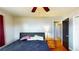 Bedroom with hardwood floors, ceiling fan, and access to hallway at 1515 W Lake Cannon Nw Dr, Winter Haven, FL 33881